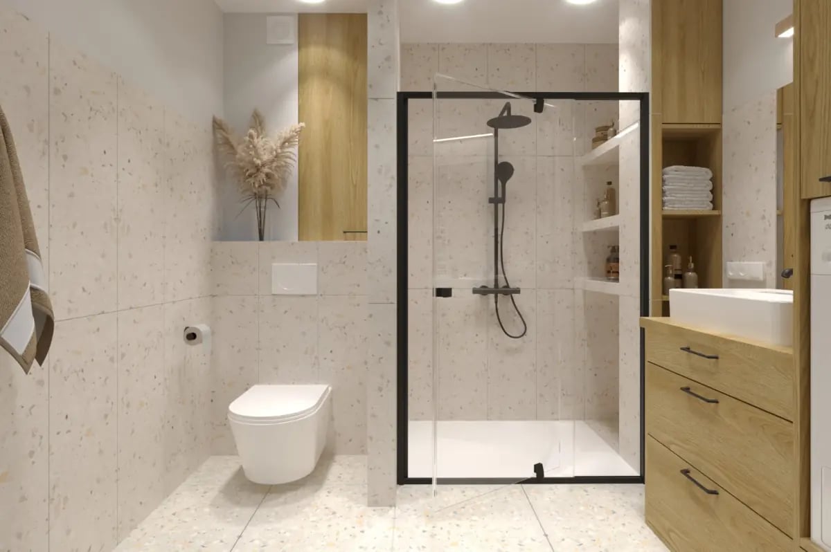 Łazienka z płytkami przypominającymi kamień. Prysznic z armaturą w kolorze czarnym. Meble drewniane.