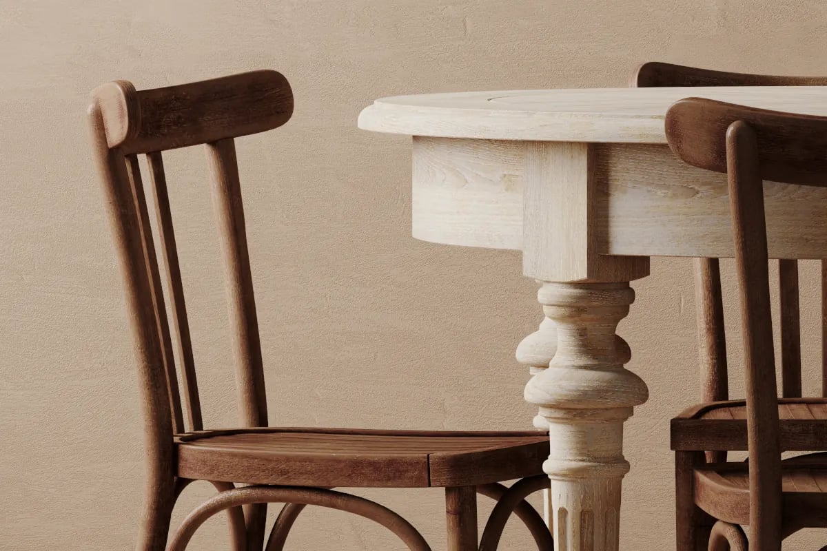 Stary drewniany stół wraz z krzesłem na tle beżowej ścianie.